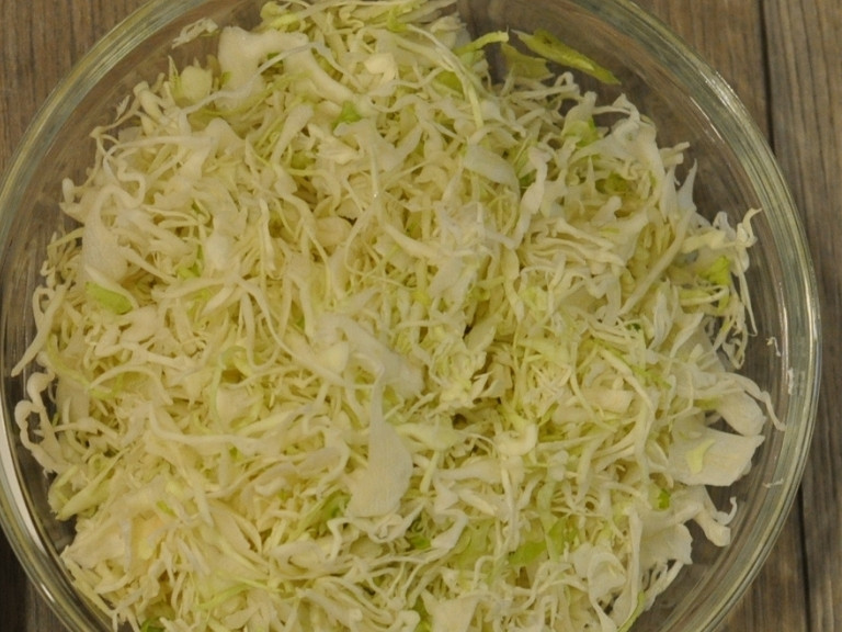 shredded cabbage in glass bowl