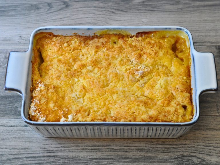 peach cobbler in blue and white baking dish
