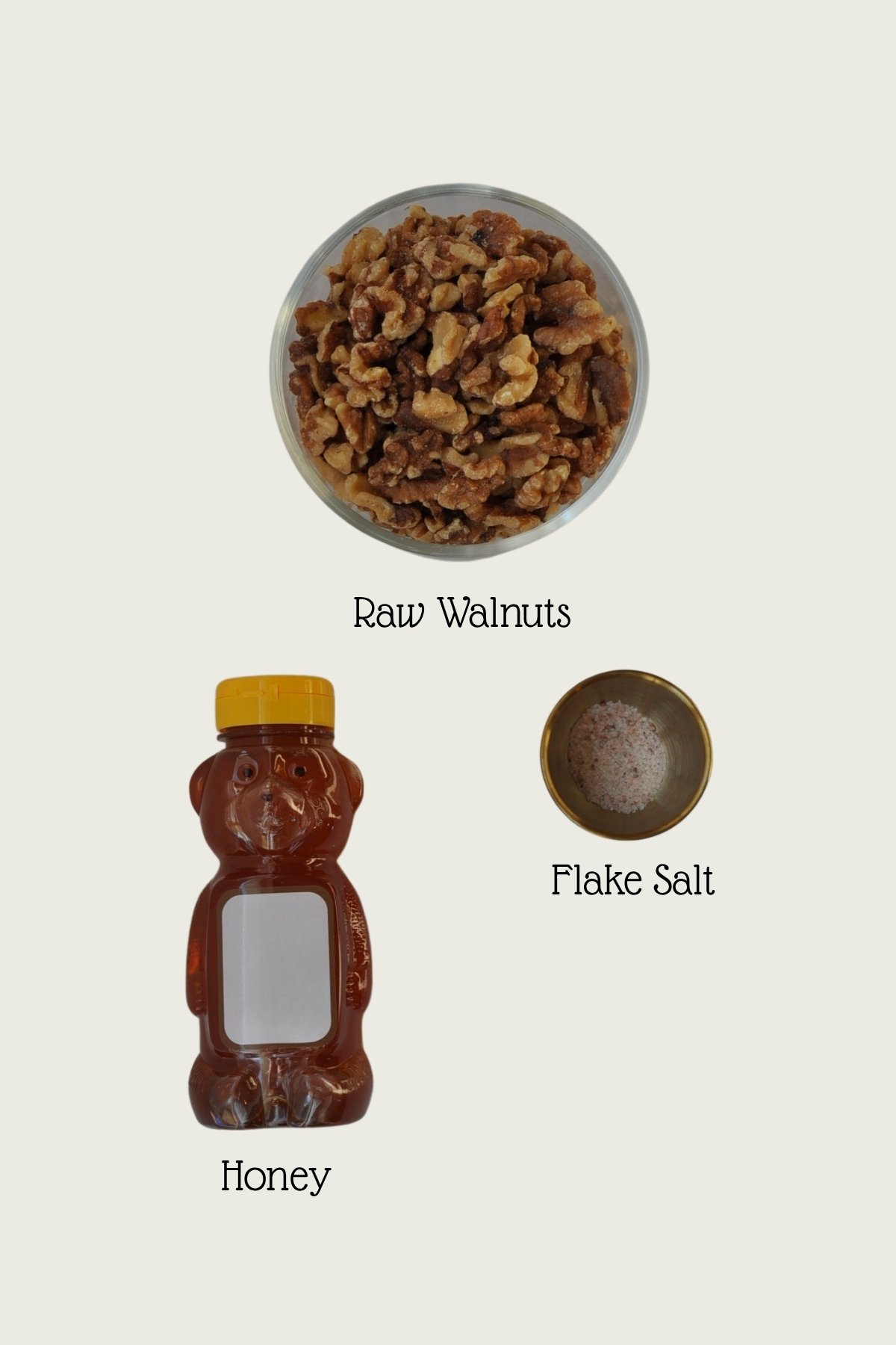 bowl of walnuts, honey in a bear looking container, salt in a gold ramekin